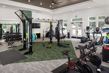 Oversized fitness club with peloton bikes, custom functional fitness escape rack, cardio equipment, and free weights